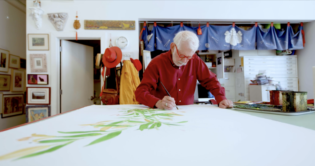 An image of Gary Bukovnik painting flowers in his studio.