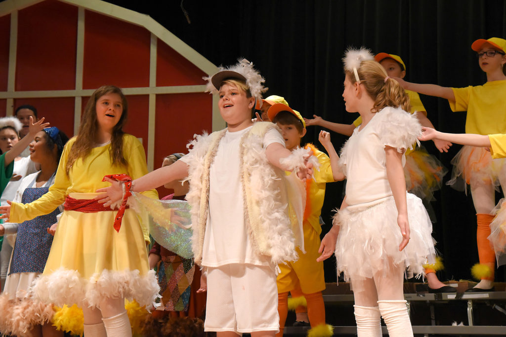 Students onstage in various costumes and positions, with main character Honk in the middle. All students appear to be mid-song.