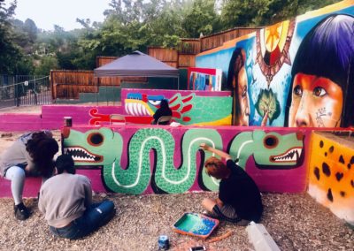 Image of a mural being painted during Restorative Justice for the Arts' Summer Mural Youth Program.