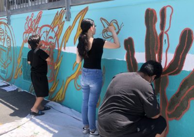 Image of a mural being painted by participants during the Yorkdale Elementary Mural Project.