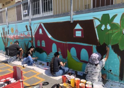 Image of a mural being painted by participants during the Yorkdale Elementary Mural Project.