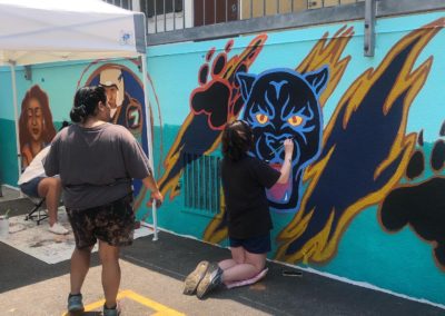 Image of a mural being painted by participants during the Yorkdale Elementary Mural Project.