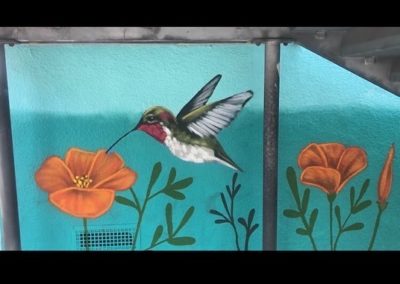Image of a mural made during the Yorkdale Elementary Mural Project. The image shows a hummingbird and orange flowers.