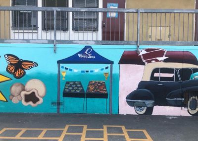 Image of a mural made during the Yorkdale Elementary Mural Project. The image shows a NELA rider car next to Villas Tacos.